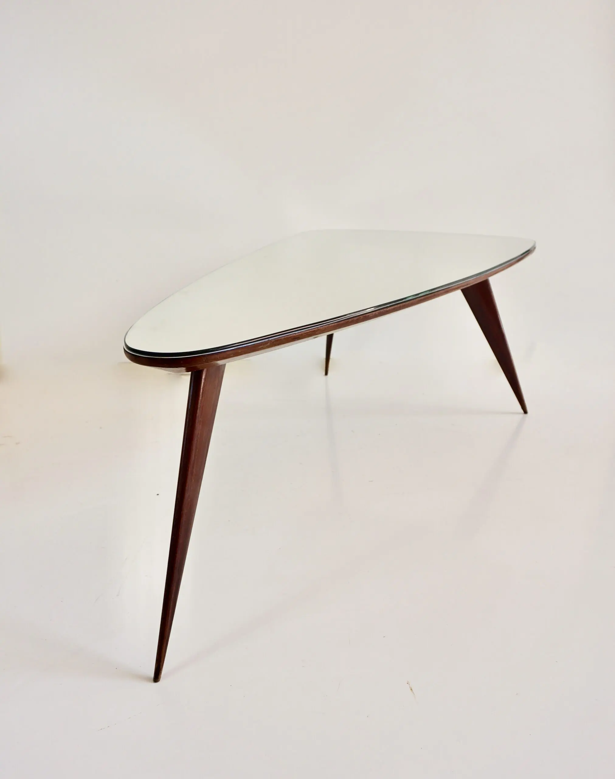 large Cesare Lacca walnut coffee table, three feet irregular shape, mirrored top — Unknown